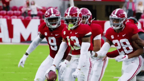 A Group Of Football Players Wearing Red Uniforms With The Number 29 On The Back GIF