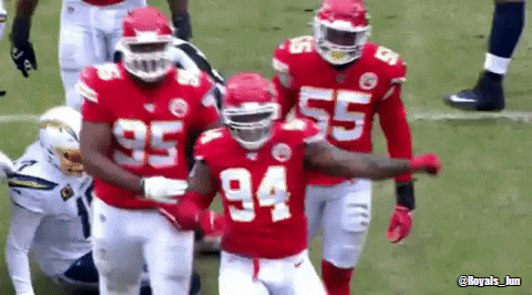 A Group Of Football Players Wearing Red Uniforms With The Number 94 On Them . GIF