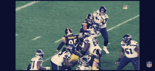 A Group Of Football Players With One Wearing The Number 51 On Their Jersey GIF