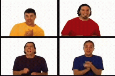 A Group Of Four Men Are Standing Next To Each Other GIF
