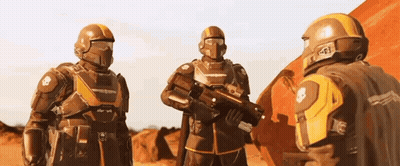 A Group Of Futuristic Soldiers Are Standing Next To Each Other On A Red Planet . GIF