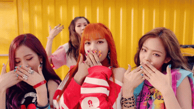 A Group Of Girls Are Covering Their Mouths With Their Hands And One Has A Shirt That Says Supreme On It GIF