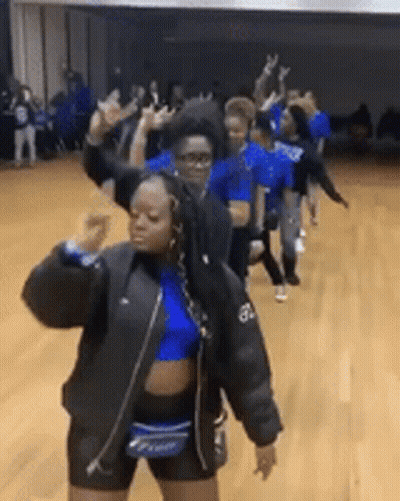 A Group Of Girls Are Dancing In A Gym . GIF
