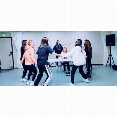 A Group Of Girls Are Dancing In A Room With A Sign On The Wall That Says " I Love You " GIF