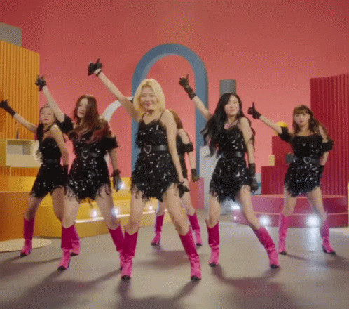 A Group Of Girls Are Dancing In Pink Boots And Black Dresses GIF