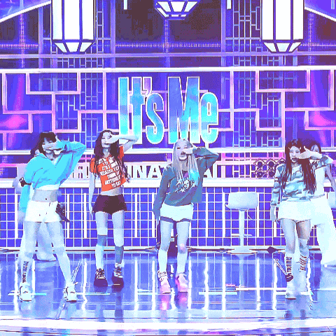 A Group Of Girls Are Dancing On A Stage In Front Of A Sign That Says ' It 'S Me ' GIF