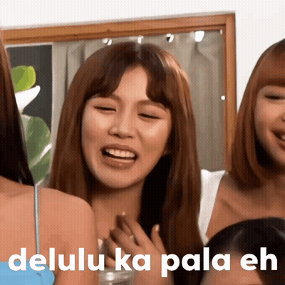 A Group Of Girls Are Laughing And One Of Them Has The Word Delulu On Her Face GIF