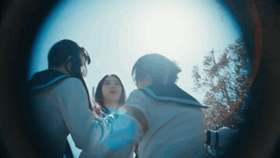 A Group Of Girls Are Standing In A Circle Looking At The Sun GIF