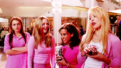 A Group Of Girls Are Standing In A Mall Wearing Pink GIF