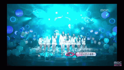 A Group Of Girls Are Standing On A Stage With Bubbles In The Background And The Words Mbc At The Bottom GIF