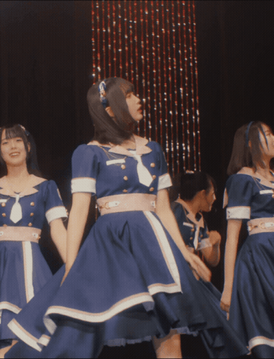 A Group Of Girls In Blue Dresses Are Dancing On Stage GIF