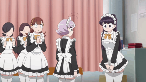 A Group Of Girls In Maid Outfits Are Standing In A Room GIF