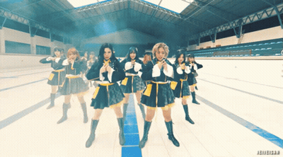 A Group Of Girls In School Uniforms Are Dancing In A Stadium With The Word Jeweler On The Bottom GIF
