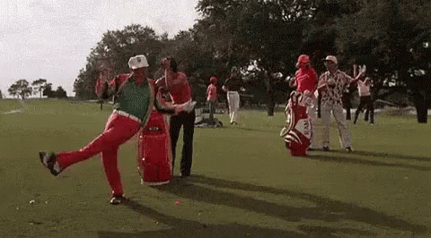 A Group Of Golfers Are Dancing On A Golf Course While Holding Golf Bags . GIF