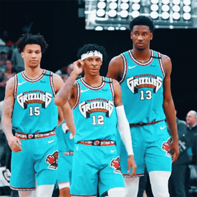A Group Of Grizzlies Basketball Players Are Standing On The Court GIF