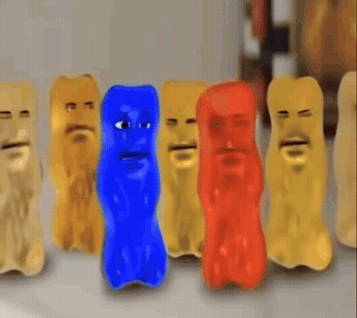 A Group Of Gummy Bears With Faces Are Lined Up In A Row GIF