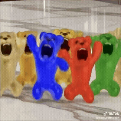 A Group Of Gummy Bears With Their Mouths Open Are Standing Next To Each Other . GIF