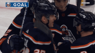 A Group Of Hockey Players Are Celebrating A Goal On A Screen GIF
