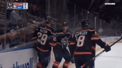 A Group Of Hockey Players Are Celebrating A Goal With The Number 29 On Their Jersey GIF