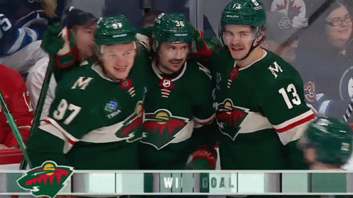 A Group Of Hockey Players Are Celebrating A Win And One Of Them Has The Number 13 On His Shirt GIF