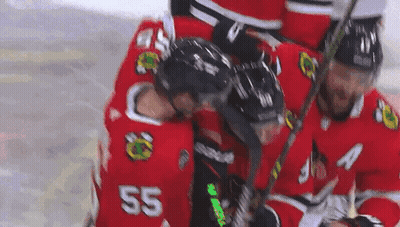 A Group Of Hockey Players Are Huddled Together On The Ice . One Of The Players Has The Number 55 On His Jersey . GIF