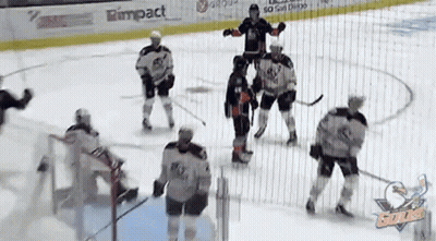 A Group Of Hockey Players Are Playing On A Rink With A Rimpact Banner On The Ice GIF
