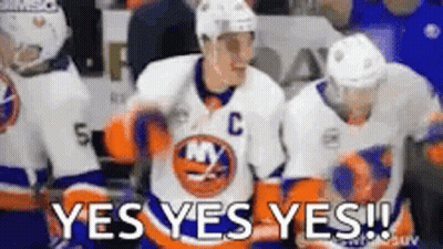A Group Of Hockey Players Are Standing On The Ice And One Of Them Is Wearing A Jersey With The Letter C On It . GIF