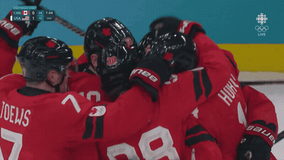A Group Of Hockey Players Huddle Together With The Number 28 On The Back Of Their Jersey GIF