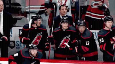 A Group Of Hockey Players Including Number 13 And 88 Are Standing On The Ice GIF