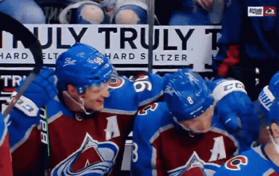A Group Of Hockey Players Standing In Front Of A Sign That Says Truly GIF