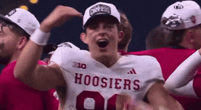 A Group Of Hoosier Football Players Are Celebrating A Win . GIF