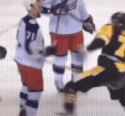 A Group Of Ice Hockey Players Are Standing On The Ice And Talking To Each Other . GIF