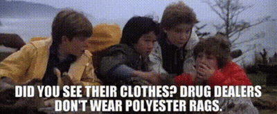 A Group Of Kids Are Laying On The Ground With The Words Did You See Their Clothes Drug Dealers Don 'T Wear Polyester Bag GIF