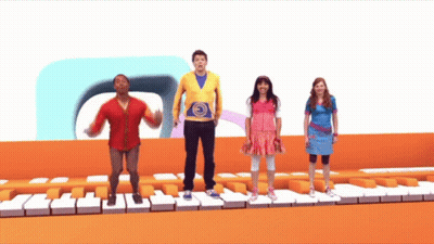 A Group Of Kids Are Standing On A Piano Keyboard GIF
