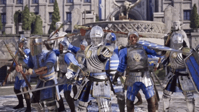 A Group Of Knights In Armor Holding Swords And Shields In Front Of A Building GIF
