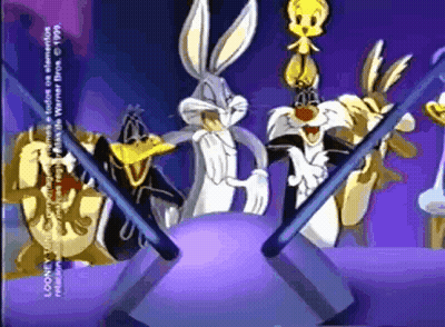 A Group Of Looney Tunes Characters Standing Around A Ball GIF