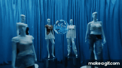 A Group Of Mannequins Are Standing In Front Of A Blue Curtain With A Make A Gif.com Logo GIF