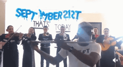 A Group Of Mariachi Players Playing In Front Of A Sign That Says September 21St That 'S Today GIF