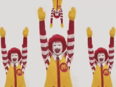 A Group Of Mcdonald 'S Mascots Are Holding Their Arms Up In The Air . GIF