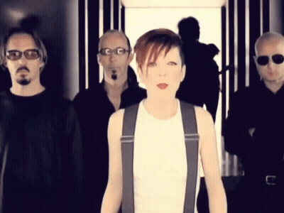 A Group Of Men And A Woman Are Standing In A Line GIF