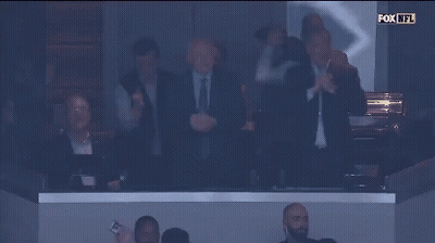 A Group Of Men Applaud In A Fox Nfl Stadium GIF