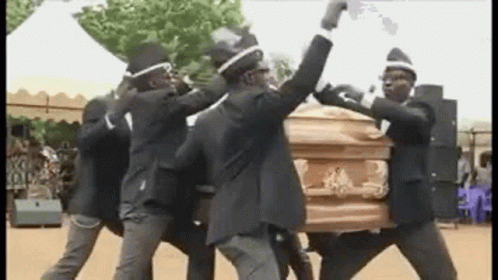 A Group Of Men Are Carrying A Coffin And Dancing . GIF