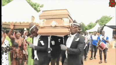 A Group Of Men Are Carrying A Coffin In A Funeral Procession GIF