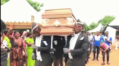 A Group Of Men Are Carrying A Coffin While Dancing GIF