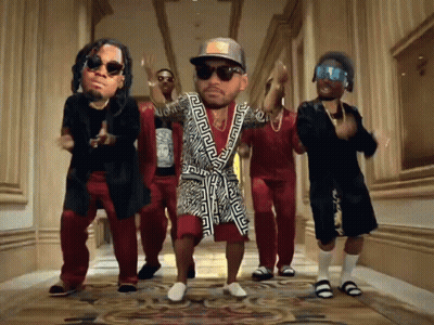 A Group Of Men Are Dancing In A Hallway With A Man Wearing A Greek Key Robe GIF