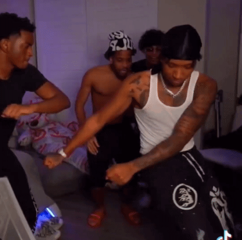A Group Of Men Are Dancing In A Room And One Of Them Has A Tattoo On His Arm GIF