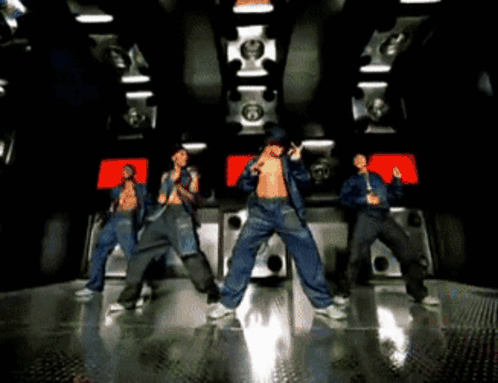 A Group Of Men Are Dancing In A Room With A Lot Of Speakers GIF