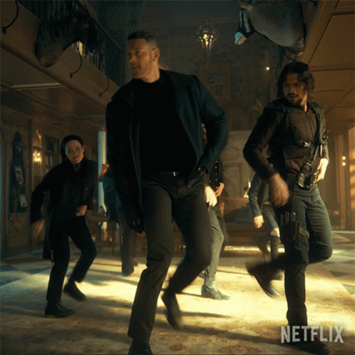 A Group Of Men Are Dancing In A Room With Netflix Written On The Bottom Right GIF