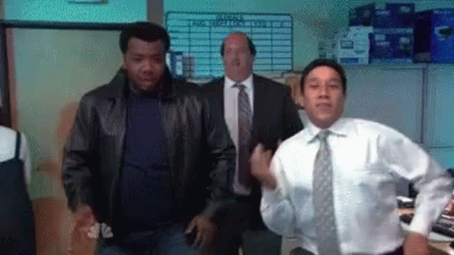 A Group Of Men Are Dancing In An Office . GIF