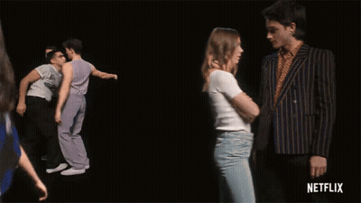A Group Of Men Are Dancing In Front Of A Black Background With Netflix Written On The Bottom GIF